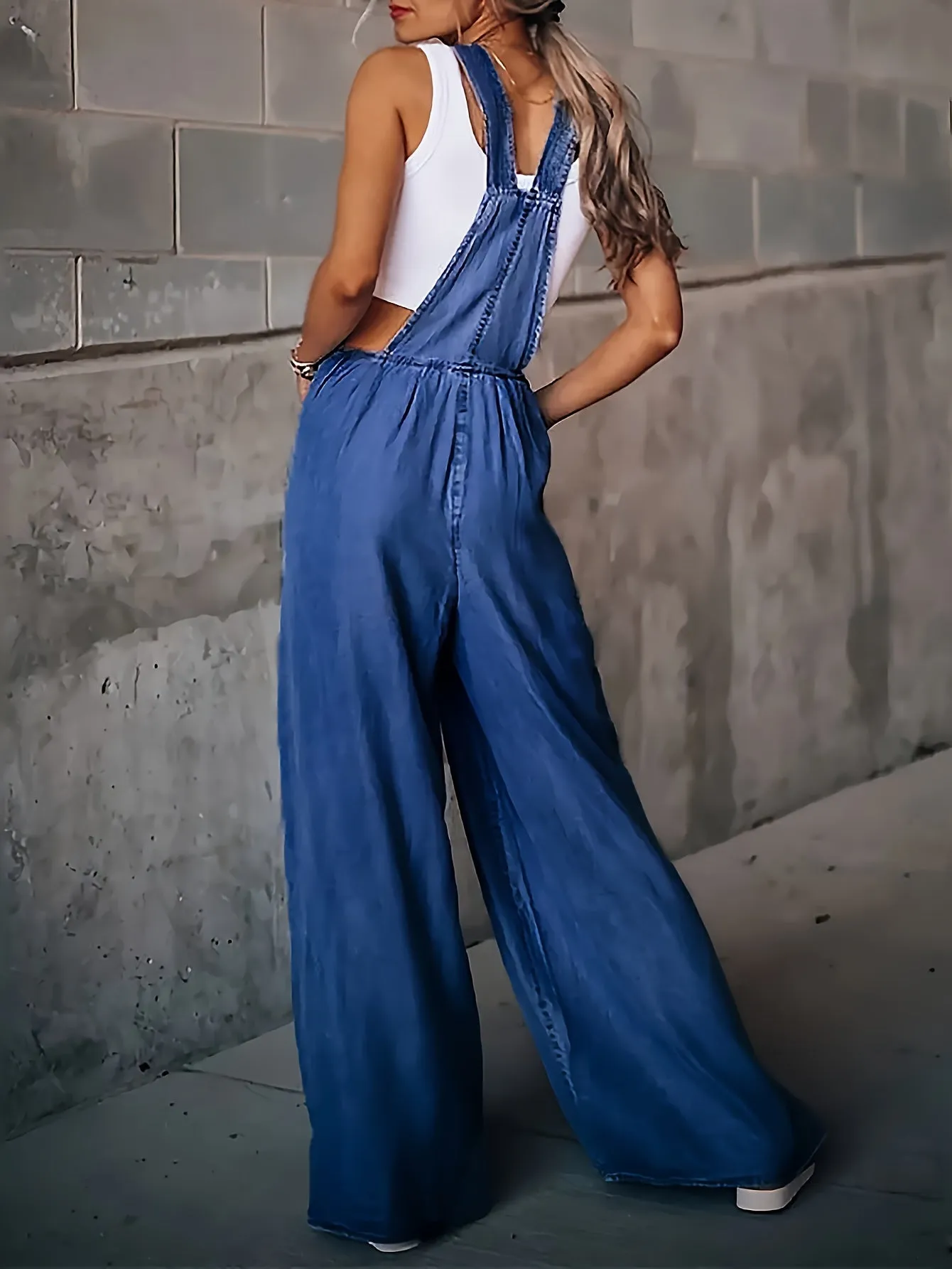 Womens Ripped Denim Jumpsuit - Fashionable Ripped Detail, Loose Fit for Comfort, Trendy Distressed Overall with Stylish Slant Pockets - Casual Everyday Denim Wear